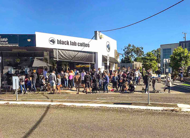 people standing outside shop