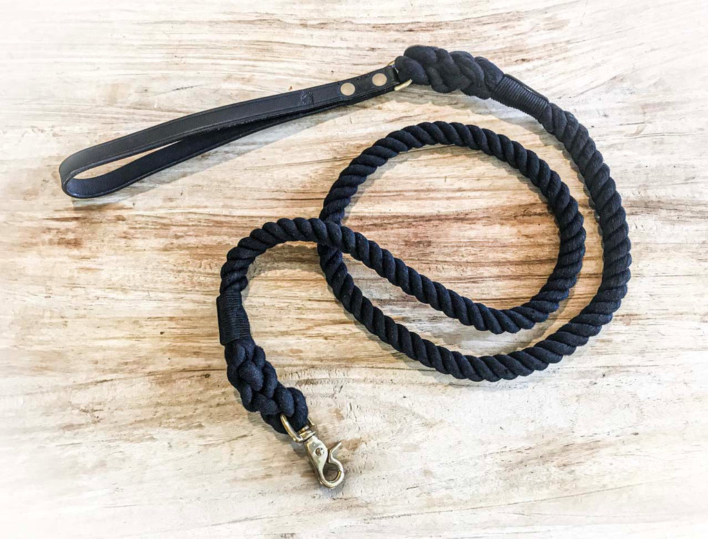 black rope dog lead laying on wood